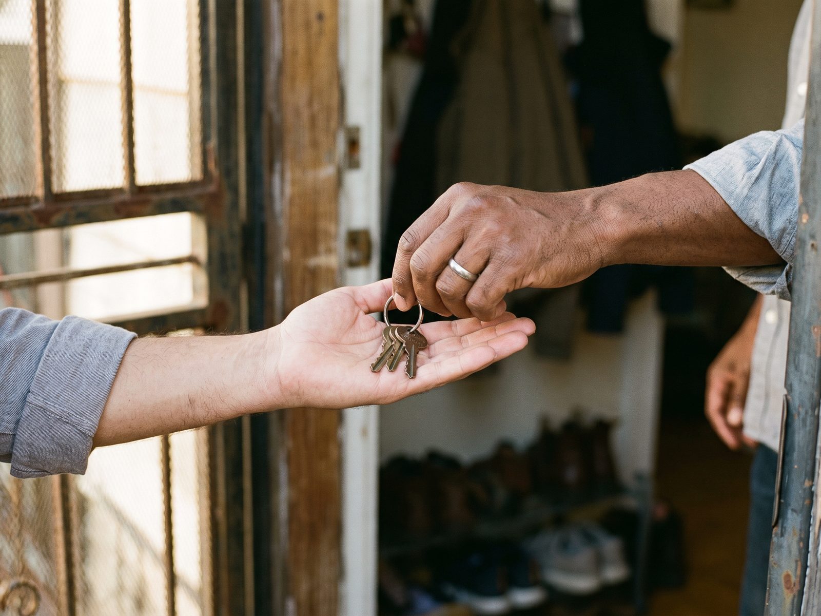 Keys being handed over at a front door